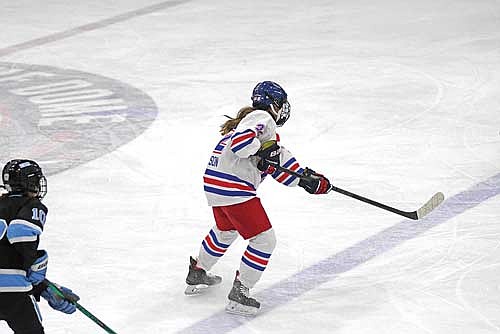 Makenzie Nicholson sends the puck up the ice in the second period of a game against Wisconsin Valley Union Monday, Dec. 22 at the Eagle River Recreation Association Sports Arena. (Photo by Brett LaBore/Lakeland Times)