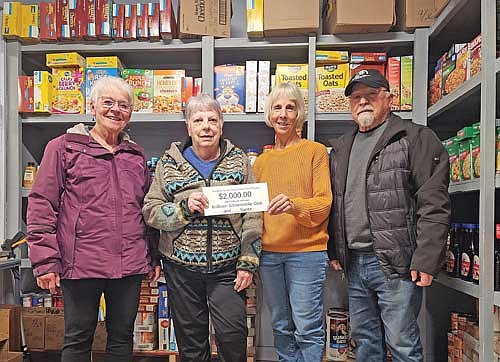 Those present for the check presentation, from left, are: club member Judy Schell, food pantry food director Sandy Weber, food pantry executive director Janlee Goska and club member Bob Schell. (Contributed photograph)