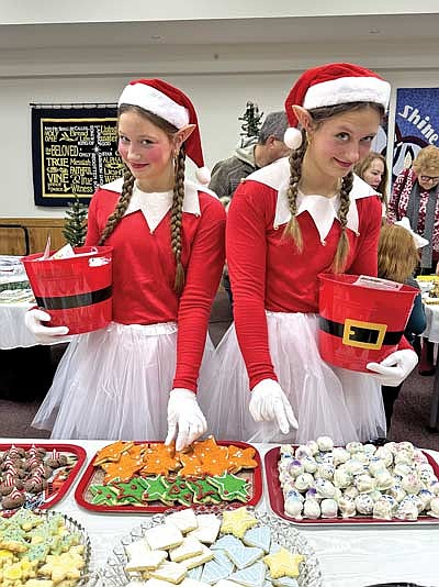 Adding to the festive atmosphere were two cheerful greeters, Elf JJ, left, aka Jaime Jorgensen, and Elf MJ, right, aka Molly Jorgensen, who welcomed shoppers with candy canes as they browsed tables filled with homemade cookies and handcrafted items. Jaime and Molly, daughters of Jeremy and Erin Jorgensen of Minocqua, brought smiles to visitors of all ages with their North Pole spirit. (Contributed photograph)