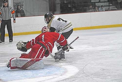 Noah Dube tries to score past Amery goalie Carter Meyer in the first period of a non-conference game Friday, Jan. 2 at the Lakeland Hawks Ice Arena in Minocqua. (Photo by Brett LaBore/Lakeland Times)