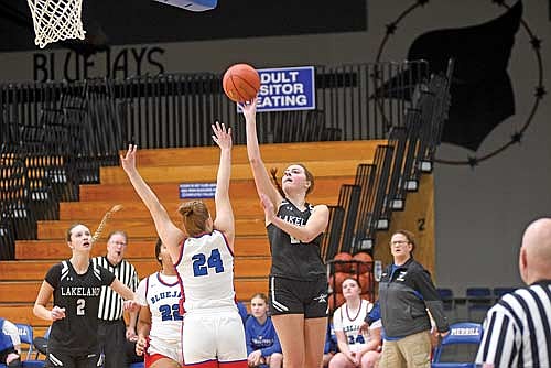 Savanah Kemnitz shoots a floater over the outstretched arm of Merrill’s Brenna Jirovec in the first half of a 43-26 win Friday, Jan. 16 at Merrill High School. (Photo by Brett LaBore/Lakeland Times)