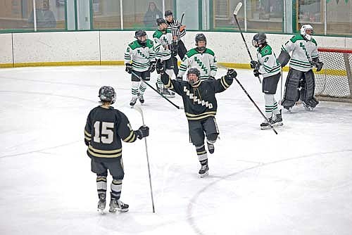 Caden Schillinger celebrates a goal with Sylvester Allen in the third period against Rhinelander Thursday, Jan. 15 at the Rhinelander Ice Arena. Schillinger and Allen scored two goals each. (Photo by Bob Mainhardt for the River News)