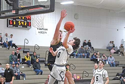 Benny Gahler delivers a layup with the foul on the contest of Wittenberg-Birnamwood’s Oliver Fraaza in the second half of a non-conference game Monday, Jan. 19 at Ted Voigt Court in Minocqua. Gahler had 18 points, the most of any scorer. (Photo by Brett LaBore/Lakeland Times)