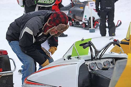 Scott Mueller judges snowmobiles during SnoFest on Saturday, Jan. 17, in Arbor Vitae. (Photo by Kate Reichl/Lakeland Times)