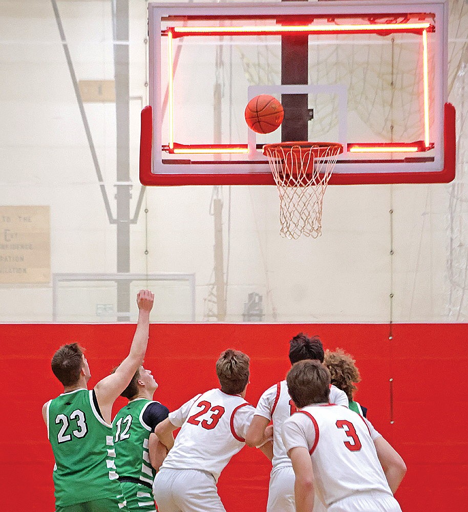 Rhinelander’s Evan Shoeder, far left, and Rowan Wiczek, second from left, watch as a putback attempt by Shawano’s Jackson Nordin, center, falls off the iron at time expires in a non-conference boys’ basketball game at Shawano Tuesday, Jan. 20. The Hodags nearly relinquished a 12-point lead over the final five-plus minutes but held on to win, 56-55. (Jeremy Mayo/River News)