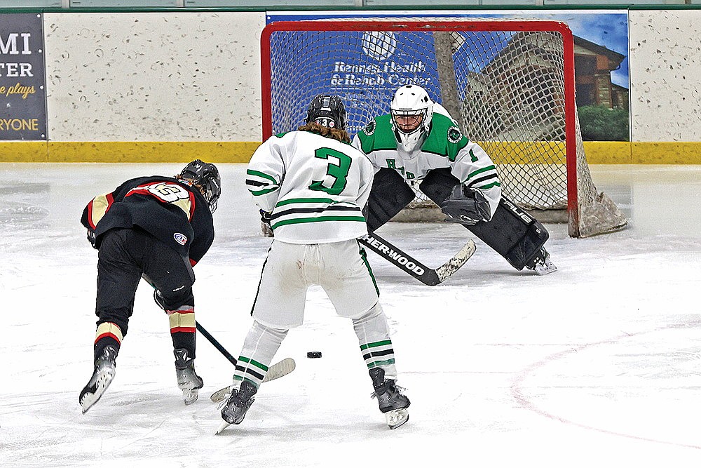 Rhinelander goalie Connor McGee faces a breakaway by Pacelli’s Dylan Cook, with Rhinelander’s Logan Leonard (3) trailing the play during the second period of a non-conference boys’ hockey game at the Rhinelander Ice Arena Thursday, Jan. 22. (Bob Mainhardt for the River News)