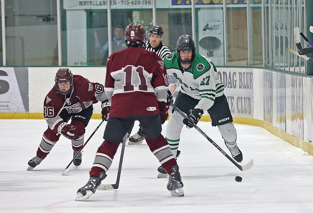 Rhinelander’s Braydon Lorman skates up the ice against Antigo’s Richie Veriha (11) and Ryder Lewis (16) during the first period of a GNC boys’ hockey game at the Rhinelander Ice Arena Tuesday, Jan. 27. (Bob Mainhardt for the River News)