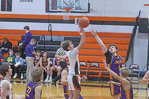 Dylan Eith makes a jumper over the outstretched arm of Drummond’s Aaron Christenson in the first half of a conference game Friday, Jan. 30 at Coach Leverson Court in Mercer. Eith led the Tigers with 11 points. (Photo by Brett LaBore/Lakeland Times)