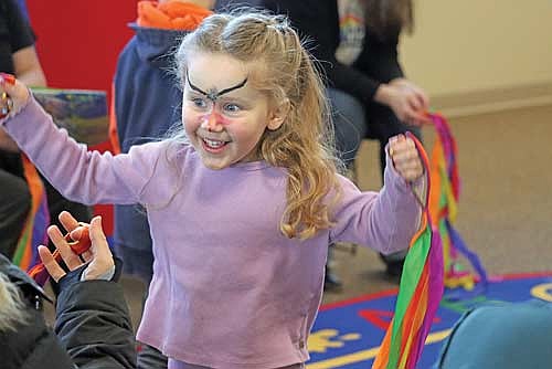 Four-year-old Mackenzie Cox has fun dancing with ribbons during Storytime on Wednesday, Jan. 28, at the Minocqua Public Library. (Photo by Kate Reichl/Lakeland Times)