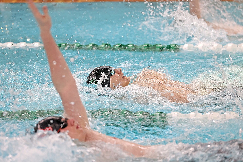 Rhinelander’s Elias Simonsen, center, races Medford’s Logan Rouiller, foreground left, in the 100-yard backstroke during a GNC double dual meet at the Heck Family Community Pool Thursday, Jan. 29. Simonsen edged Rouiller by 0.11 seconds to win the event, one of nine victories for the Hodags as they defeated the Raiders 135-28 and the Shawano/Seymour Thunderhawks 122-48. (Bob Mainhardt for the River News)