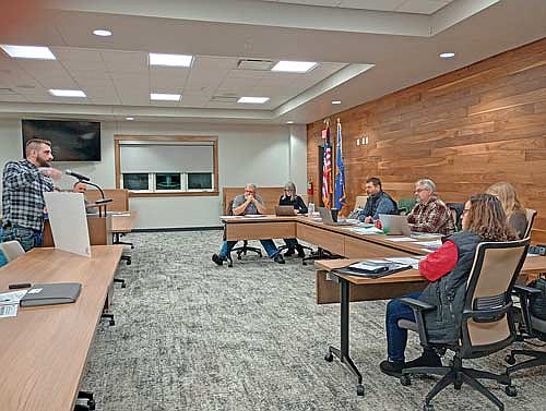 Eric Borchardt, left, shows Newbold town officials (l-r around the table) Brad White, Petra Pietrzak, Scott Ridderbusch, Dan Hess, Kim Gauthier, and Jodie Hess a drawing of what he envisions for the former Newbold School at last Thursday’s Newbold Town Board meeting. (Photo by Ardith Carlton/River News)