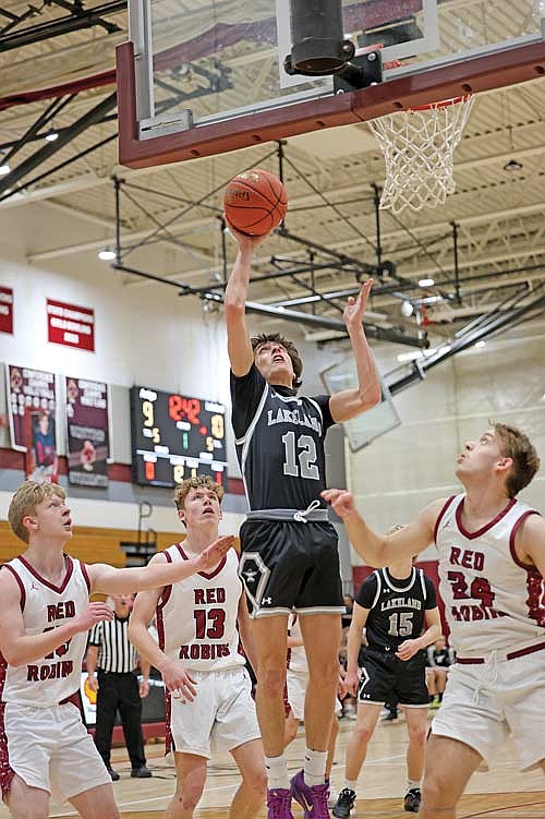 Deklan McQuade looks for a basket in the paint surrounded by a trio of Antigo players Friday, Feb. 6 at Sheldon Fieldhouse in Antigo. (Antigo Sports Photography)