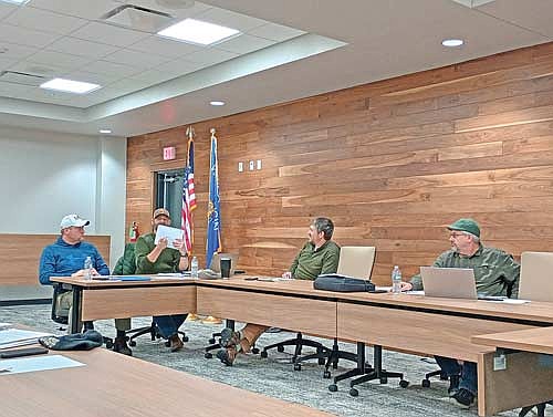 Scott Ridderbusch, second from left, illustrates a theoretical parcel bisection for fellow Newbold plan commission members (l-r) Ryan Rezny, Nick Vos and chairman Dan Hess at the commission’s meeting Thursday, Feb. 5.­­ (Photo by Ardith Carlton/River News)