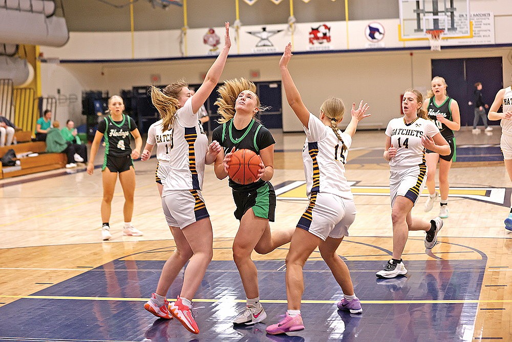Rhinelander’s Aubryn Clark drives between Tomahawk’s Lauren Riebe (13) and Autumn Merrigan (15) during the first half of a GNC girls’ basketball game at Tomahawk Tuesday, Feb. 10. Clark scored a team-high 24 points in the Hodags’ 81-45 victory. (Bob Mainhardt for the River News)