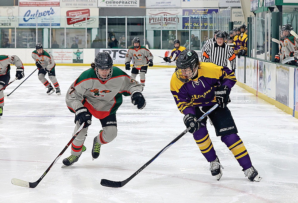 Rhinelander’s Logan Leonard carries the puck in the offensive zone against Chequamegon/Phillips’s Kameryn Roberts during the third period of a non-conference boys’ hockey game at the Rhinelander Ice Arena Thursday, Feb. 12. (Bob Mainhardt for the River News)
