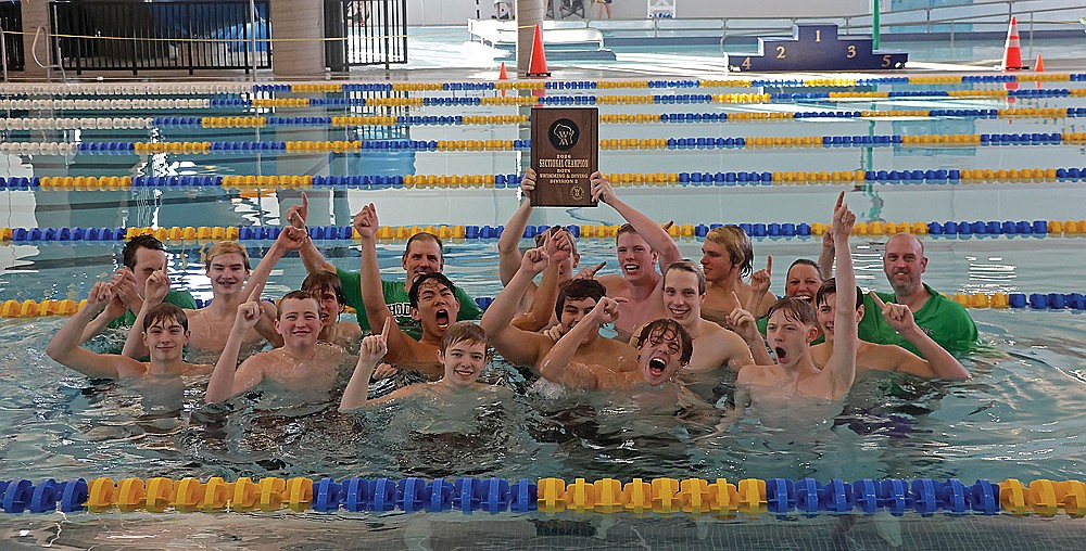 The RHS boys’ swim team celebrates in the water the WIAA Division 2 boys’ swimming sectional championship plaque following the sectional meet in Rice Lake Saturday, Feb. 14. In the front row, from left to right, are Paul Denis, Finn Thorsen, Broden Wagner, Konner Bex and Espen McMahon. In the second row are Matthew Wood, Charlie Antonuk, Chris Larson, Judson O’Malley and Dean Gillingham. In the back row are coach Dolan O’Malley, Kaleb Lehmann, coach Dan Jesse, Elias Simonsen, Kellen O’Malley, Daniel Meier, head coach Jenny Heck and coach Brent Olson. (Jeremy Mayo/River News)