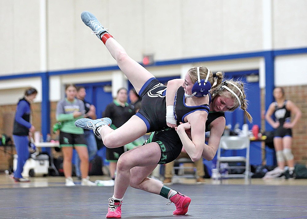In this Feb. 3, 2026 contributed photograph, Rhinelander’s Cassidy Lindner throws Merrill’s Kendell Klug to the match during an invite in Merrill. Lindner pinned Klug Friday, Feb. 13 to earn the title at 120 pounds in a WIAA girls’ wrestling regional tournament in Merrill. (Contributed photograph)