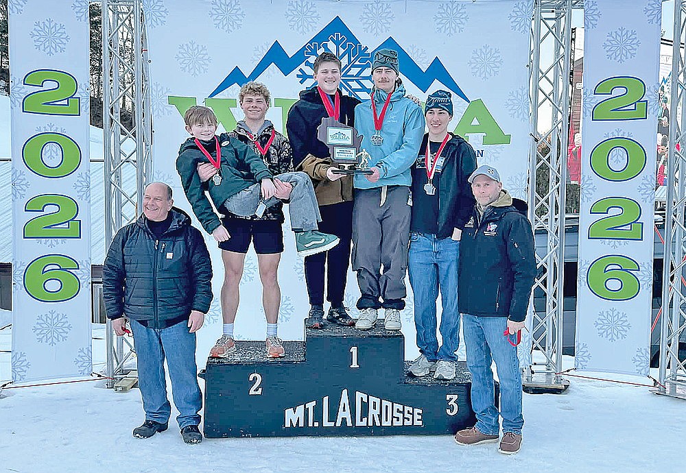 The Rhinelander/Northland Pines boys’ snowboard team stands on the podium after finishing second overall at the WIARA state meet in La Crosse Saturday, Feb. 14. Pictured, from left to right, are coach Greg McGuire, middle school team member Eli Sarkauskas, Ayden Myers, Soren Dumar, Marshal Durkee, Kamden Kostrova and coach Rod Olson. (Contributed photograph)