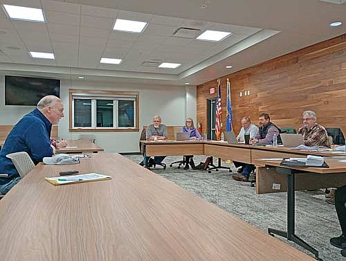 Town assessor Jef Muelver, left, discusses intricacies of revaluation with the Newbold town board last Thursday, Feb. 12. (Photo by Ardith Carlton/River News)
