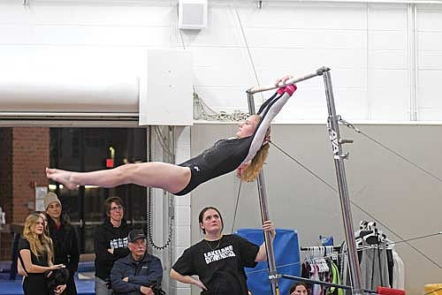 Claire Elbe swings on the uneven bars during a conference dual meet against Antigo Tuesday, Feb. 17 at Lakeland Union High School in Minocqua. Elbe won the uneven bars with a score of 7.1. (Photo by Brett LaBore/Lakeland Times)