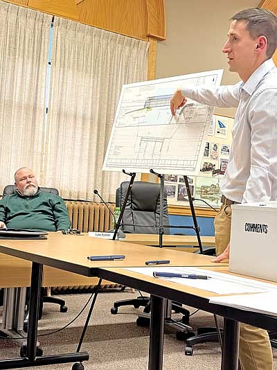 Rhinelander city administrator Patrick Reagan, left, listens as Ryan Schaitel, a transportation engineer with Ayers Transportation, refers to a drawing as he answers a question during a public information meeting regarding the replacement of the 70-year old Kemp Street bridge on Feb. 16. (Photo by Brian Jopek/Lakeland Times)