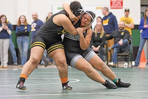 Kady Lohoff, right, and Green Bay United’s Kyla Brasier grab each other in a first-round matchup at 235 pounds during a WIAA sectional meet Friday, Feb. 20 at D.C. Everest Senior High School in Weston. (Photo by Brett LaBore/Lakeland Times)