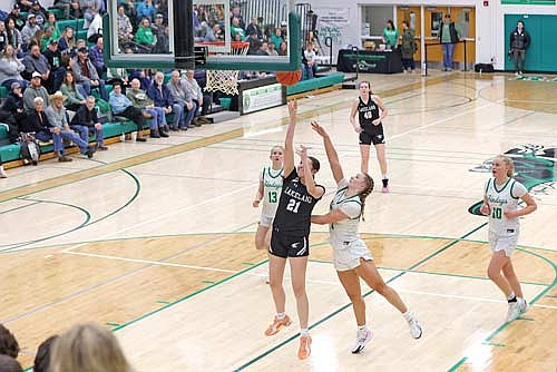 Britta Kemnitz takes a shot in the paint against the contest of Rhinelander’s Aubryn Clark in the second half of a conference game Friday, Feb. 20 at the Jim Miazga Community Gymnasium in Rhinelander. (Photo by Bob Mainhardt for the River News)