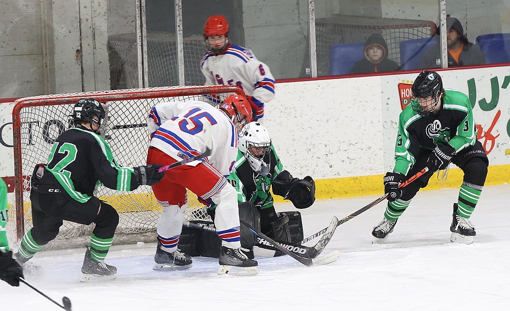 Rhinelander goalie Connor McGee tries to stop a point-blank chance by Northland Pines forward Jazek Jantzen (15) while defenders Logan Leonard (3) and Dylan Shefveland (12) attempt to break up the play during the second period of a WIAA Division 2 boys’ hockey playoff game at the Eagle River Sports Arena Thursday, Feb. 19. Northland Pines defeated Rhinelander, 10-2. (Bob Mainhardt for the RIver News)