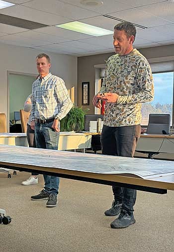 Trace Hubbard, left, a civil engineer with Ayers Civil-Municipal Engineering, listens as Minocqua public works director Mark Pertile provides an overview of a bicycle/pedestrian path project planned for Minocqua’s west side during a public information meeting on Thursday, Feb. 26. (Photo by Brian Jopek/Lakeland Times)