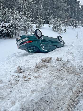 The Ford Escort of Matthew Podrez, Crandon, wound up upside-down Tuesday after sliding across the median and into the opposite ditch of icy U.S. Highway 8 in Pelican. (Contributed photograph)