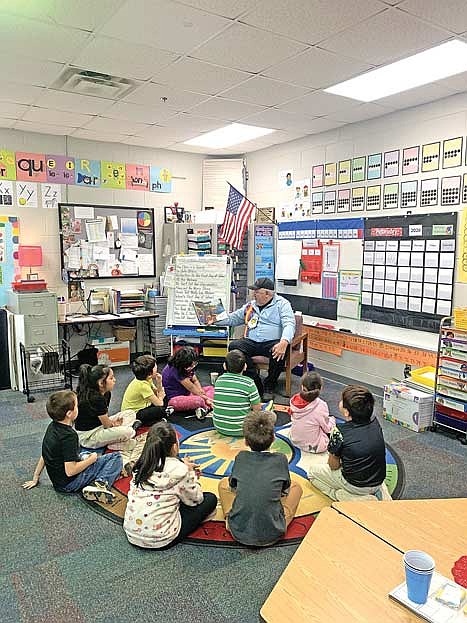 Lac du Flambeau tribal president John Johnson Sr. reads aloud to Patti Maulson's first grade class during World Read Aloud Day on Wednesday, Feb. 4, in Lac du Flambeau. (Contributed photograph)