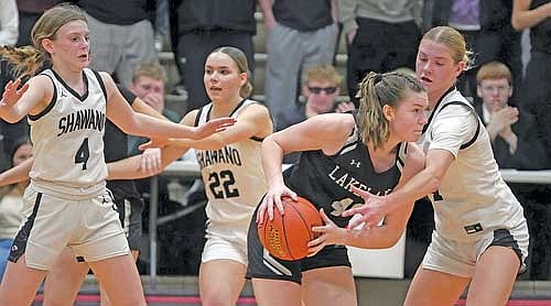 Ava Evenhouse possesses the ball surrounded by Shawano’s Jadyn Brown (4) and Leah Nordin, right, in a WIAA Division 2 regional semifinal game Friday, Feb. 27 at Shawano Community High School. Evenhouse led the Thunderbirds with 21 points. (Photo by Greg Mellis/Shawano Leader)