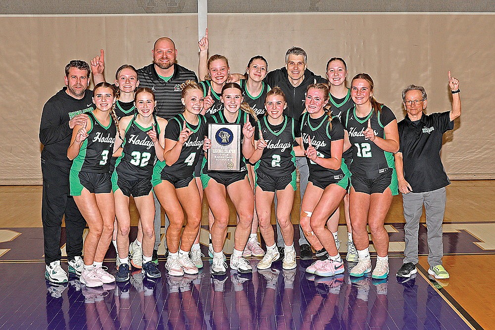 The Rhinelander High School girls’ basketball team poses with the WIAA Division 2 regional championship plaque after defeating Marinette 47-43 in Marinette Saturday, Feb. 28. Pictured in the front row, from left to right, are Kenzie Paulson, Kara Monk, Teagan Clark, Aubryn Clark, Maddie Paulson, Vivian Lamers, Ella Miljevich and coach Terry Nordine. In the back row are coach Brian Paulson, Ellie Cummings, coach Tyler Beran, Lexi Beran, Lily Kurilla, head coach Ryan Clark and Gracie Anderson. The Hodags won their first regional title since 2020 and will face Shawano Thursday in the sectional semifinals. (Bob Mainhardt for the River News)