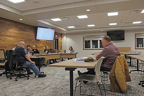 Newbold public works director Mark Fetzer, right, suggests possibilities for this year’s road projects to the town board at the Thursday, Feb. 26, Newbold town board meeting. (Photo by Ardith Carlton/River News)
