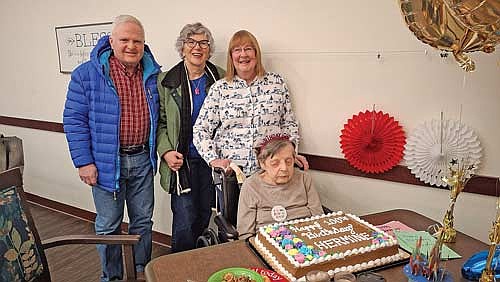 Hermine Zink and her neighbors and friends, from left, Greg Gill, Kathy Krohn-Gill and Roberta Gast, pose for a picture over Zink’s 100th birthday cake on Monday, Feb. 23, in Woodruff. (Contributed photograph)