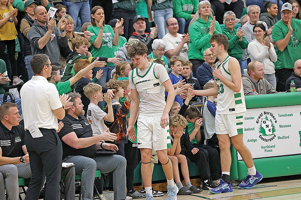 Rhinelander seniors Jatyn Barkus, center, and Evan Shoeder come to the bench late in the second half of a WIAA Division 2 boys’ basketball regional final game against Menomonie at the Jim Miazga Community Gymnasium Saturday, March 7. The Hodags lost to Menomonie, 65-51, falling in the regional finals for a second year in a row. (Bob Mainhardt for the River News)