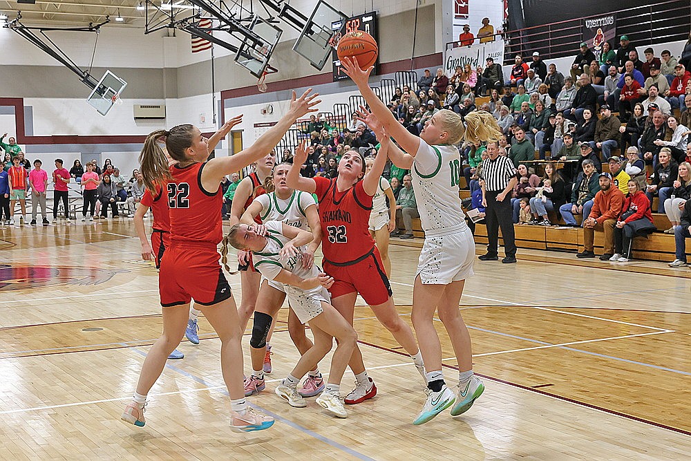 Players, including Shawano Anna Dreier (22) and Creden Weisnicht (32), and Rhinelander’s Maddie Paulson, Vivian Lamers and Lexi Beran (10) battle for a rebound during the first half of a WIAA Division 2 sectional semifinal game in Antigo Thursday, March 5. (Bob Mainhardt for the River News)