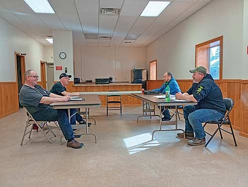 From left to right, Pelican town supervisors James Cates and Walter Dahlquist Jr., town clerk Mike Ring and road supervisor and shop foreman Mike Carroll have a discussion during a Pelican town board meeting Monday, March 9. (Photo by Ardith Carlton/River News)
