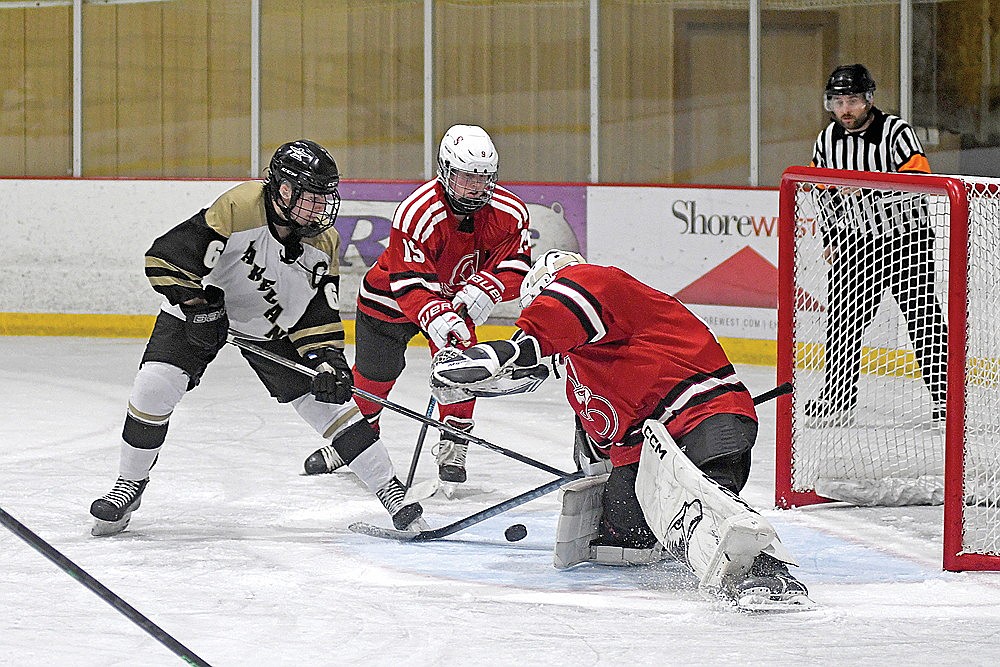In this Feb. 19, 2026 file photo, Lakeland’s Lawson Bain tips a puck in front of Shawano/Bonduel goalie Tyson Lyons and defender Wyatt Schroeder (19) during a WIAA Division 2 boys’ hockey regional final game in Minocqua. The WIAA Board of Control has approved Shawano/Bonduel’s request to join the GNC in boys’ hockey for the 2027-28 season. The GNC could grow as large as 10 teams by that season if Merrill’s fast-track request to join the GNC is approved by the WIAA board. That request is expected to be heard by the board of control following the current conference realignment cycle in April. (Brett LaBore/Lakeland Times)