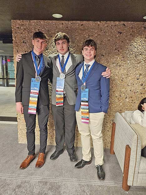 From left to right, Josh Haselton, Sam Caselton and Kam Kostrova of Rhinelander High School were recognized onstage for their seventh-place performance in the Community Service Giving Project at the Feb. 22-25 DECA state competition in Lake Geneva. (Contributed photograph)