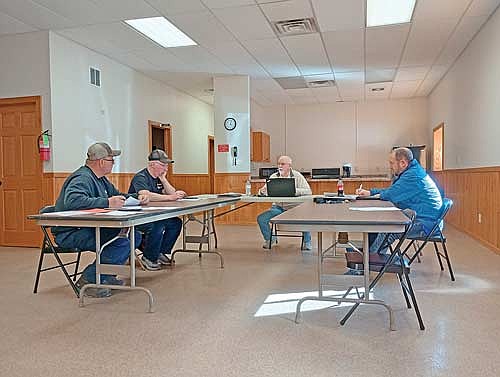 From left to right, supervisors James Cates, Walter Dahlquist Jr. and chair Nick Scholtes, joined by town clerk Mike Ring, mull over a quandary concerning the Haymeadow Bridge at their March 23 meeting. (Photo by Ardith Carlton/River News)