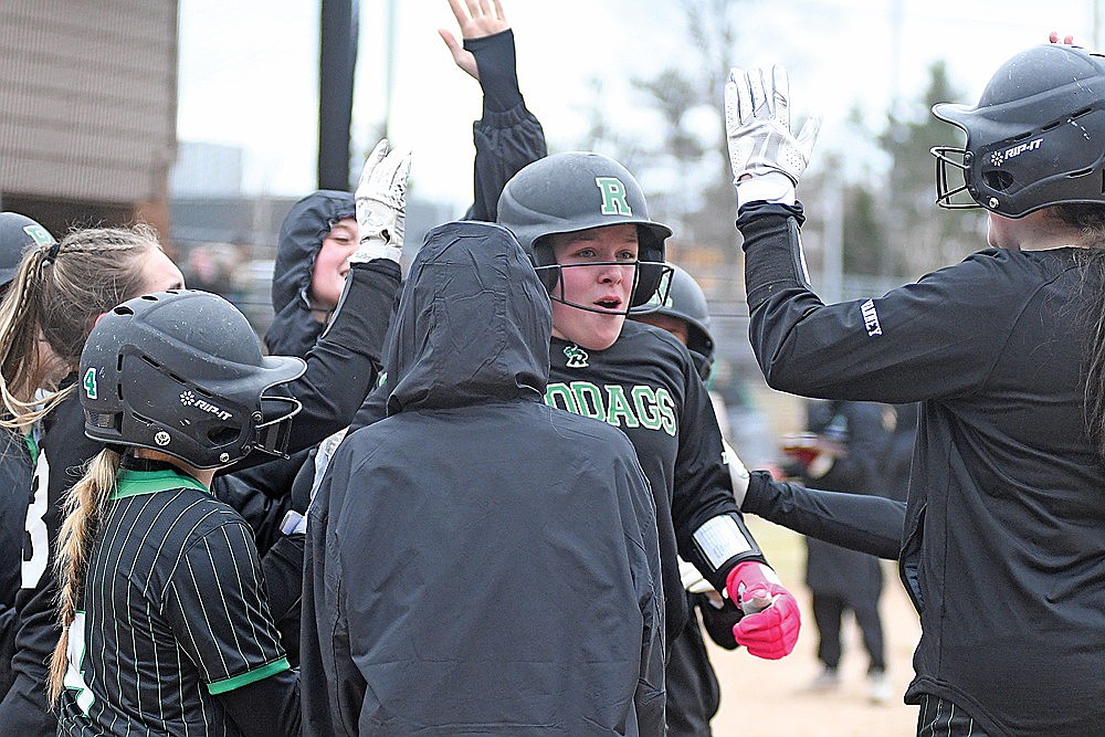 Rhinelander’s Kadyn Taylor is congratulated by teammates after hitting a grand slam home run during the fourth inning of a GNC softball game against Lakeland in Minocqua Tuesday, March 31. (Bob Mainhardt for the River News)