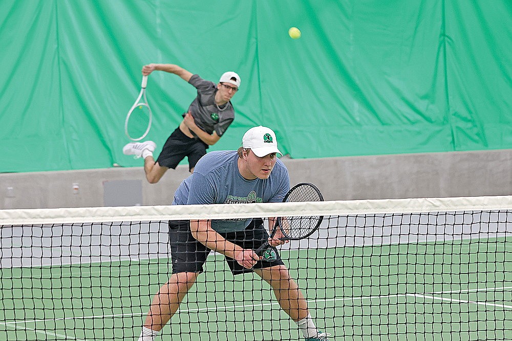 Danek Koniar stares down his opponents as teammate Asher Rivord serves during a doubles exhibition.