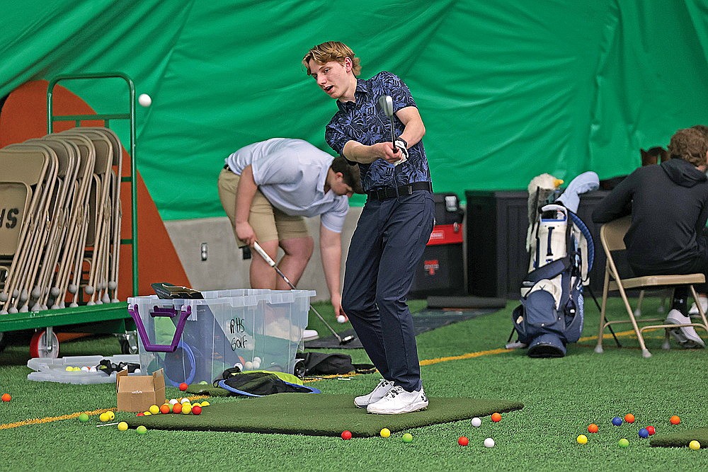 Sophomore Grant Gremban chips during Rhinelander High School golf practice in the Hodag Dome Monday, March 30. (Bob Mainhardt for the River News)