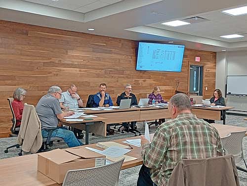 Mark Fetzer (foreground), Newbold’s director of public works, presented possible 2026 road projects and bid specs to the Newbold town board at their meeting March 26. (Photo by Ardith Carlton/River News)