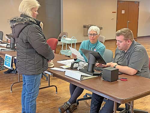 Woodruff resident Sherry Otto, left, waits as election inspector Andrea Billings and poll worker Will Handrick verify her identification prior to her voting at Woodruff’s Michael K. Timmons Community Center on Tuesday, April 7. (Photo by Brian Jopek/Lakeland Times)