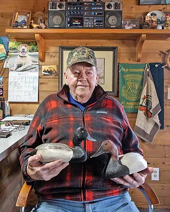 Kenley Cordts holds his decoys in the very hands that carved them. (Photo by Blake Richard/River News)