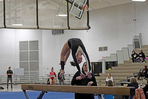 In this Feb. 21, 2026 file photo, Malin Awker does a back handspring on balance beam during the Great Northern Conference meet at the Lakeland Union High School fieldhouse in Minocqua. Awker was an all-conference gymnast and made it to the state meet her freshman season. (Photo by Brett LaBore/Lakeland Times)