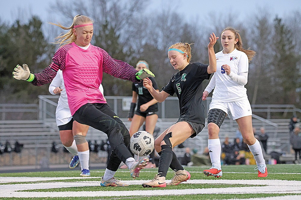 Rhinelander’s Jordan Manske tries to get off a shot in front of Northland Pines goalkeeper Sammy Nampel during the second half of a GNC girls’ soccer game at Mike Webster Stadium Thursday, April 9. (Blake Richard/River News)