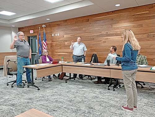 From left, standing for their official ceremony, returning town supervisors Brad White and Mike McKenzie are sworn in by town clerk Kim Gauthier at the Newbold town board meeting on Thursday, April 9. (Photo by Ardith Carlton/River News)